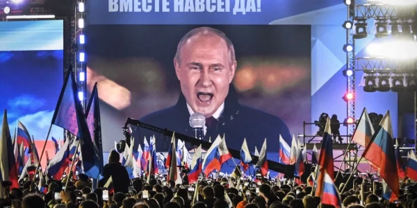 Vladimir Putin speaking at a campaign rally, showcasing his leadership bid for Russia's presidency.
