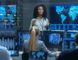 A cybersecurity manager in a high-tech operations center, monitoring multiple screens displaying real-time threats, working alongside a team to strategize and implement security measures against cyber attacks.